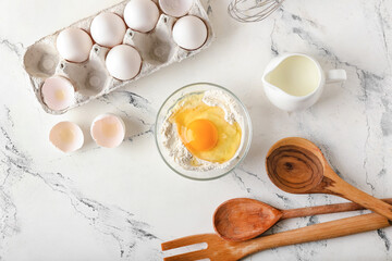 Ingredients for preparing bakery and utensils on light background