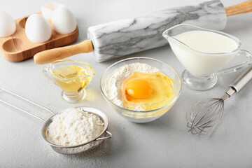 Ingredients for preparing bakery and utensils on light background