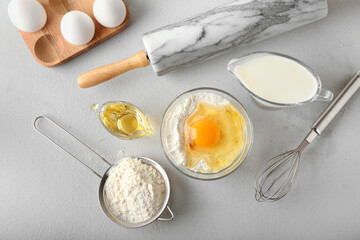 Ingredients for preparing bakery and utensils on light background