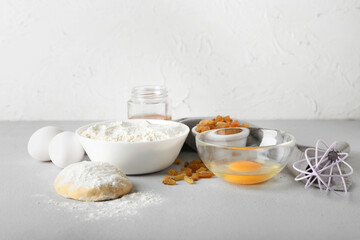 Obraz na płótnie Canvas Ingredients for preparing bakery and utensils on light background