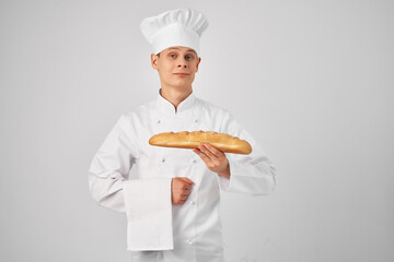 Baker in Chef's Clothes Holding a loaf of food cooking fresh