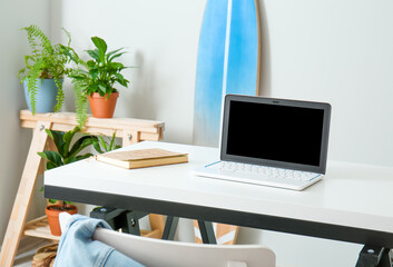 Table with laptop in modern room