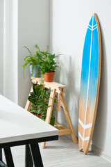 Interior of modern stylish room with surfboard