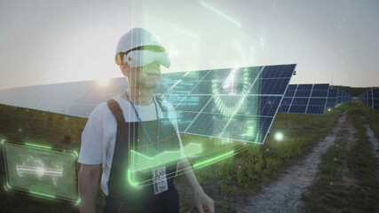 Professional technician worker in VR glasses working online with solar battery panels checking energy. 3D hologram graphic. Sunset sky. Futuristic technology innovation. Eco business. Virtual reality.