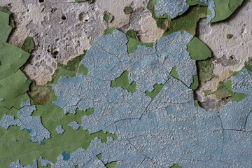 Peeling paint on the wall. Old concrete wall with cracked flaking paint. Weathered rough painted surface with patterns of cracks and peeling. High resolution texture for background and design. Closeup
