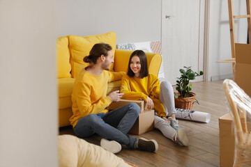 Young couple in their new house on moving day