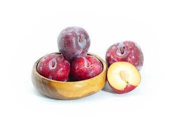 Fresh plum in wooden bowl on background, Healthy food.