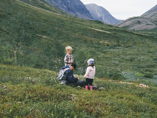 Fototapeta na wymiar family hiking in the mountains with children, travel