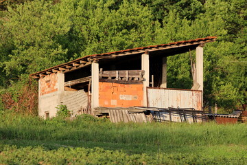 Unfinished grey concrete and red building blocks outdoor building filled with various construction...