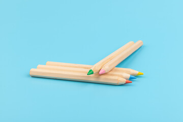 Fototapeta premium Wooden colorful ordinary pencils isolated on blue background. Back to school