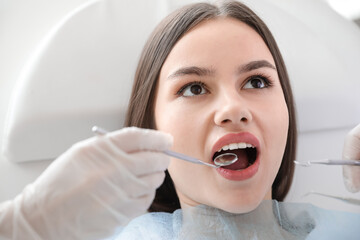 Young woman visiting dentist in clinic, closeup