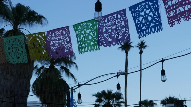 Mexican perforated papel picado banner, festival flags, paper tissue garland. Colorful hispanic folk carved street decor for fiesta, holiday or carnival in Latin America, Day of Dead or Dia De Muertos