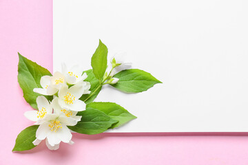 Blank sheet of paper and beautiful jasmine flowers on color background