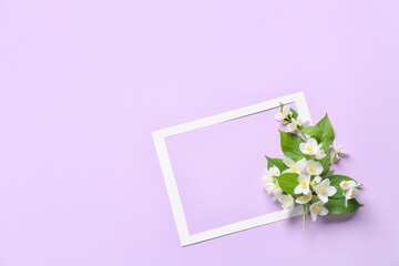 Composition with beautiful jasmine flowers and paper frame on color background