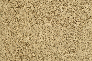 The texture of the decorative wall of an eco house made of straw or vine.