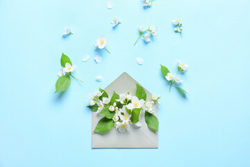 Envelope with beautiful jasmine flowers on color background