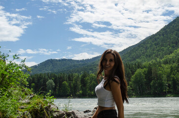 Fototapeta na wymiar happy girl smiling on a background of mountains