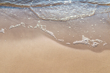 Soft wave of the sea on the sandy beach.Soft focus,blurred image.