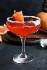 Glass of Hemingway daiquiri cocktail on dark background