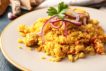 Plate with tasty pilaf on dark background, closeup