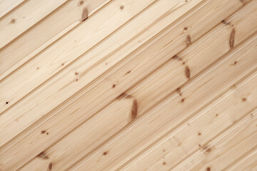 Close-up of clapboard wall. Fragment of diagonal wooden planks. Decorating material. Wood texture...
