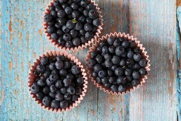 Blueberries on the table. Berries in bowls and in a jar.