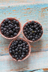 Blueberries on the table. Berries in bowls and in a jar.