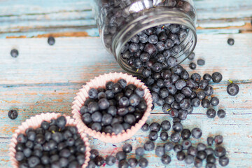 Blueberries on the table. Berries in bowls and in a jar.