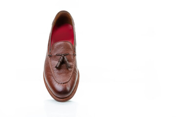 Footwear Concepts. One Right Side Traditional Formal Stylish Brown Pebble Grain Tassel Loafer Shoe On White Reflective Surface.