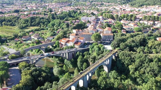 General view from drone of Ceret town on banks of river Tech in foothills of Pyrenees mountains in summer, France
