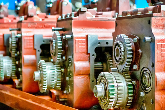 New Freshly Lubricated Cogwheels of Tractors Gearboxes Located Together At Production Facility.