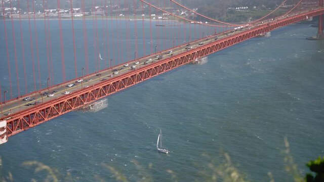 Closeup of the Golden Gate Bridge and cars passing by