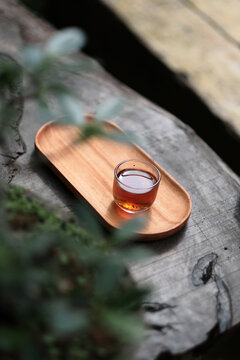 Romantic morning. Wooden tea table, tea cup. Interior green tones. High quality photo