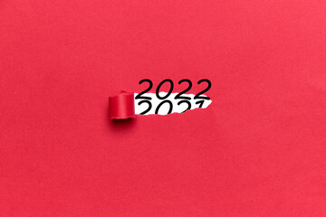 Number 2022 coming out of a torn red cardboard. Concept New Year