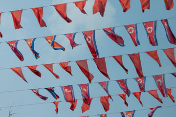 North Korea national flags flutter against the blue sky