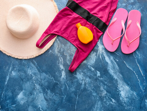 Set of beach accessories on color background