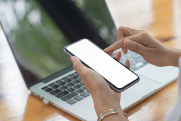 Cropped shot of professional businesswoman holding blank screen smartphone in a modern office room.