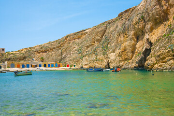 Stunning view of Inland sea brown rock cliffs and boats near the shore on a sunny day