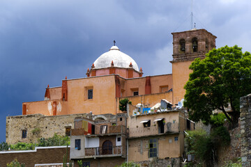 Fototapeta na wymiar Guanajuato, Mexico - Church looming over Santa Domingo