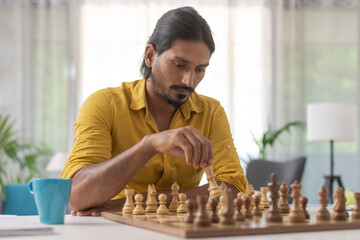 Man playing chess at home