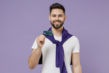 Satisfied beautiful smiling young brunet man 20s wears white t-shirt purple shirt hold in hand...