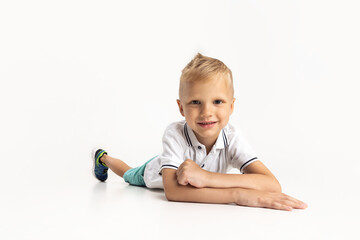 Portrait of cute preschool boy isolated on white studio background. Copyspace for ad. Childhood, education, emotion concept