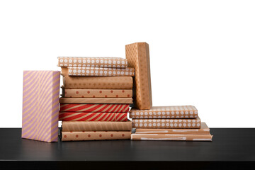Stack of books on wooden table against white background