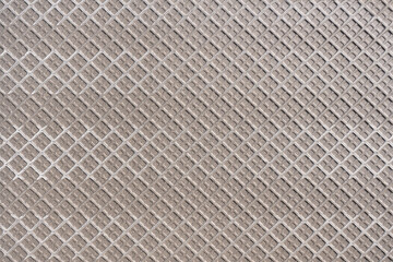 Hellbraune Rückseite einer großen Fliese mit Muster aus Quadraten in Nahaufnahme