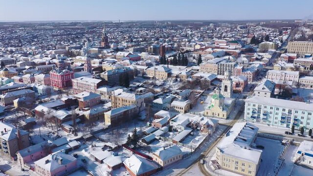 Scenic aerial view of covered with snow houses and churches in Russian city of Yelets on sunny winter day, Lipetsk Oblast