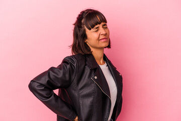 Young mixed race woman isolated on pink background suffering a back pain.
