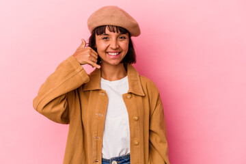 Young mixed race woman isolated on pink background showing a mobile phone call gesture with fingers.