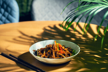 Sweet and sour pork with wok vegetables in a white bowl. Chinese cuisine.
