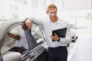 Man happy customer male buyer client in white shirt hold clipboard papers document lean on car...