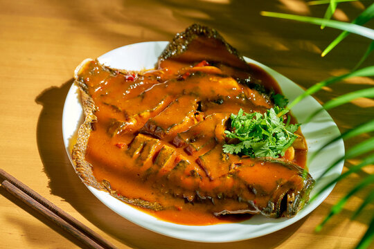 Spicy whole flounder fried with sweet and sour sauce. Chinese cuisine.
